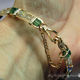 A 14K GF wire-wrapped bracelet with green and crystal AB  stones, shown worn on a person's wrist.